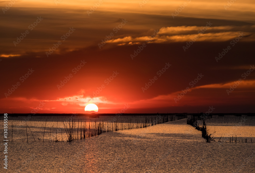 Obraz premium Beautiful sunset above sea in thailand. Silhouette of fish farms