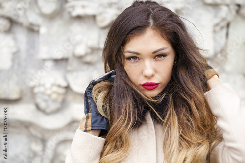 Young beautiful woman in beige coat