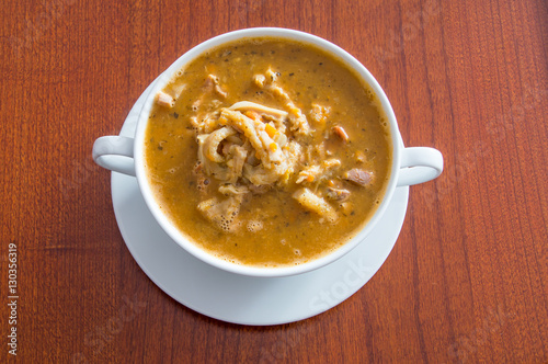 Polish beef tripe soup  known as Flaki po Zamojsku  in a white bowl.