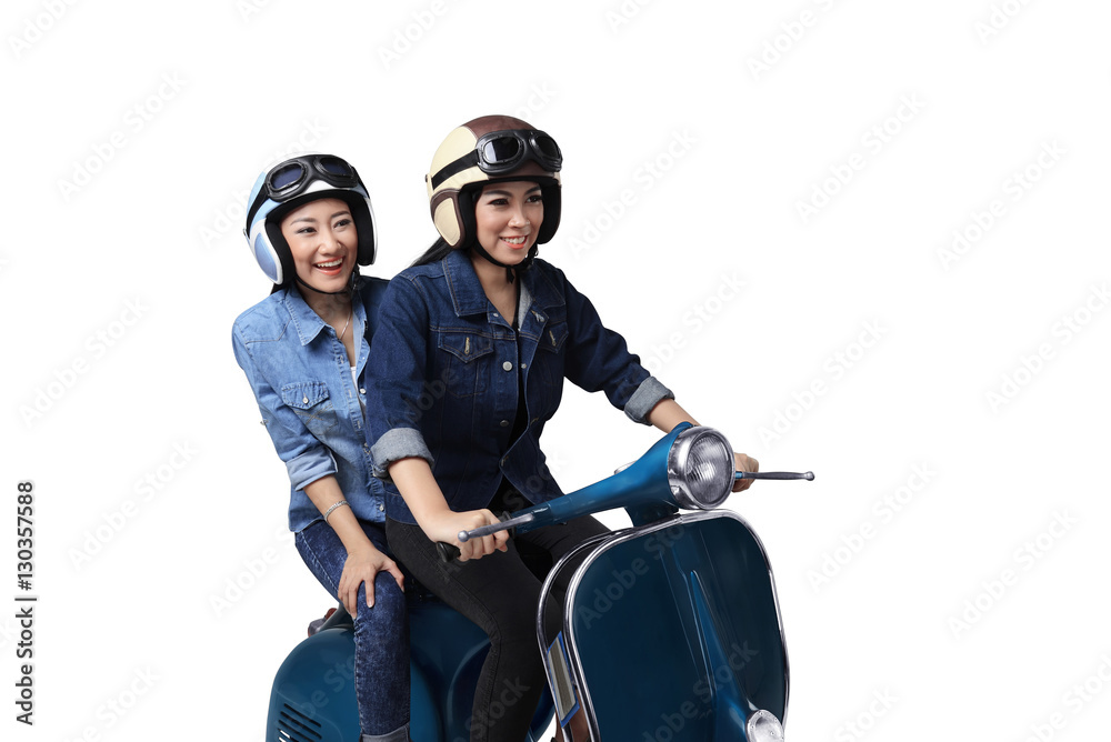 Naklejka premium Two asian woman having fun when riding the scooter