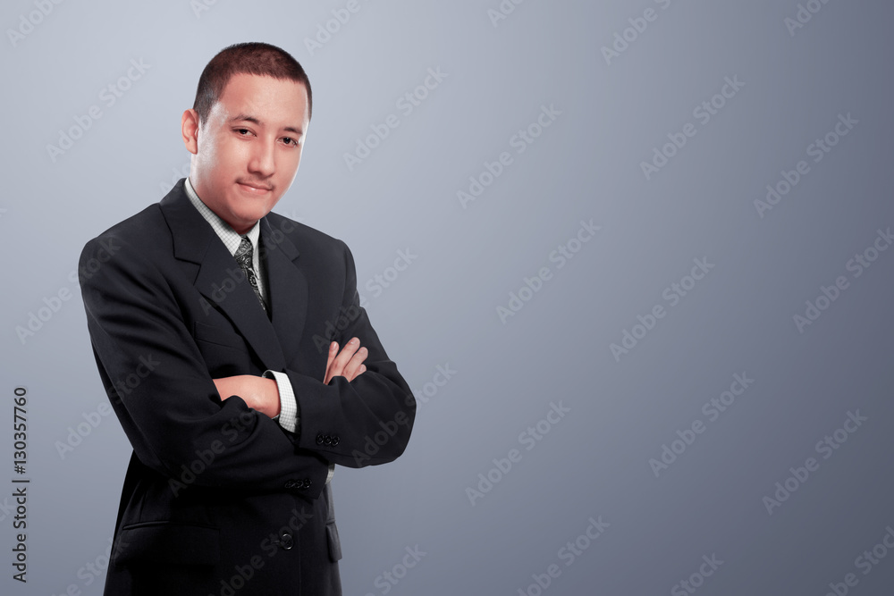 Asian businessman with arms crossed standing over grey background Asian businessman with arms crossed standing over grey background
