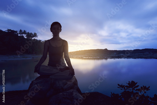 Asian woman pose when doing yoga over the rock © Leo Lintang