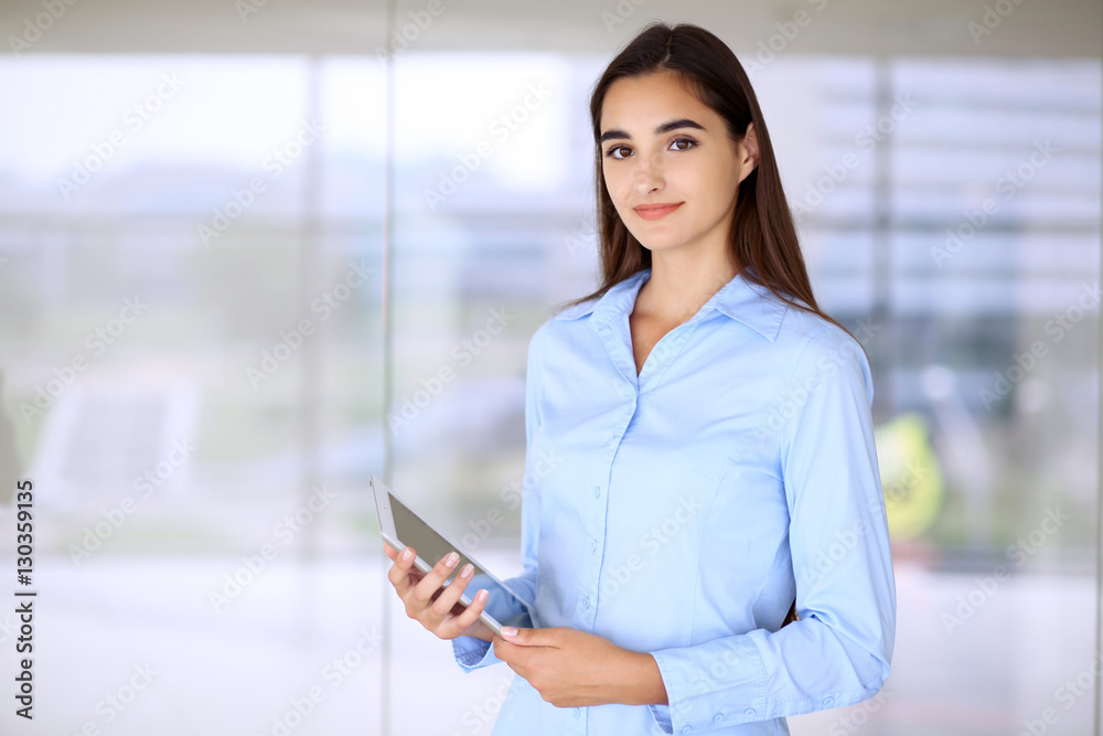 Young brunette businesswoman or student girl looking at camera