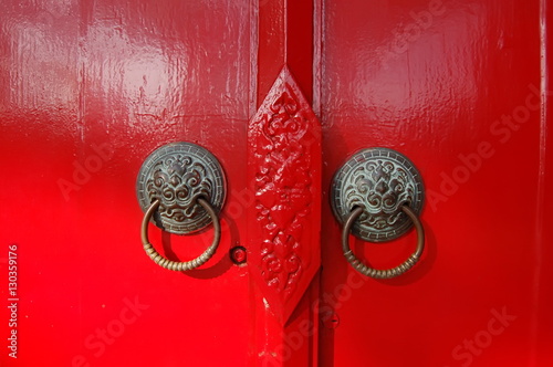 Door handles on red door.