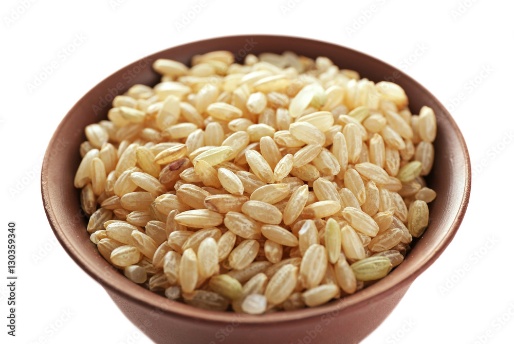 Brown short grain rice in cup closeup Brown short grain rice in cup closeup
