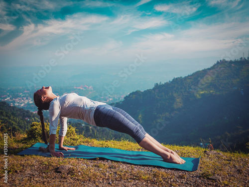 Woman doing Hatha yoga asana Purvottanasana