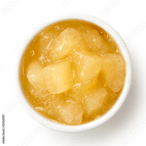 Bramley apple sauce in ceramic bowl isolated on white from above.