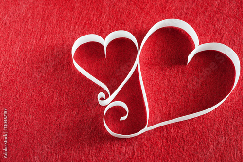 Valentine day background  handmade paper hearts on red felt