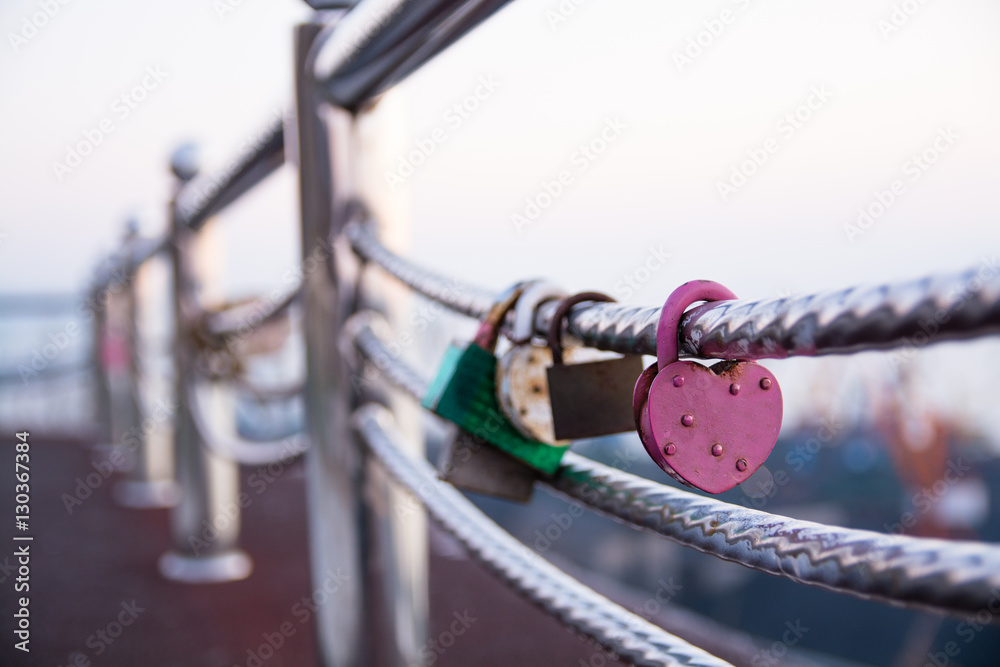 Wedding lock in shape of heart on a handrail. Wedding lock in shape of heart on a handrail.
