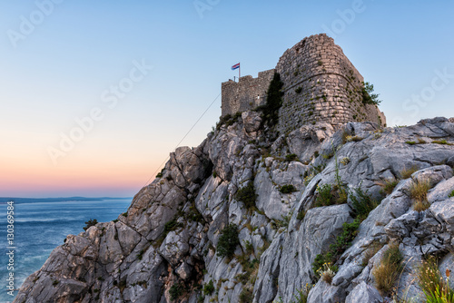 Old fortress on the top of the rocky Dinara mountain over Adriatic sea, Omis, Croatia photo