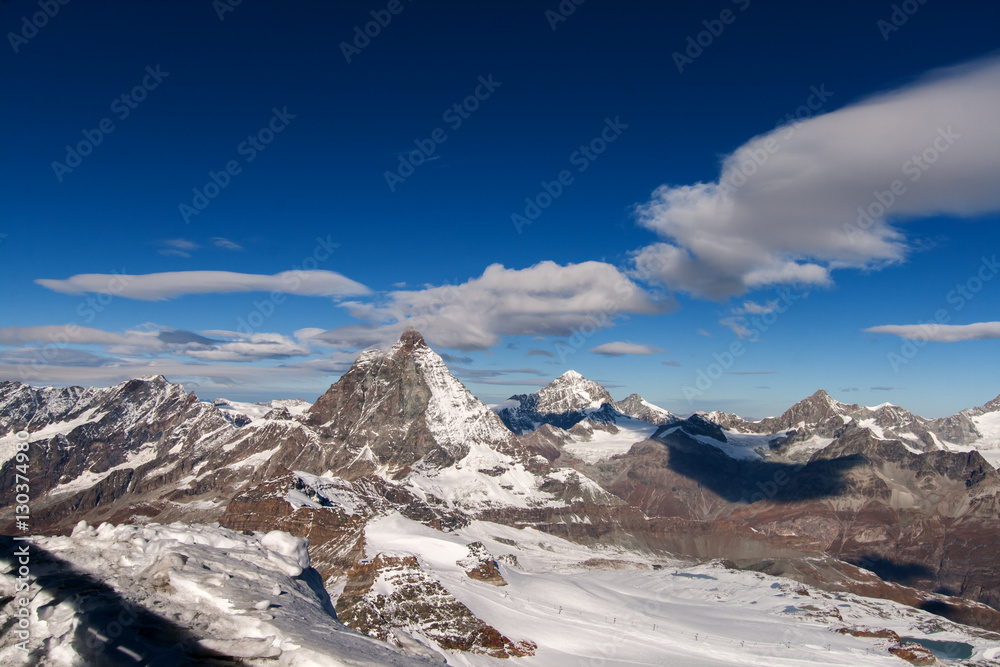 Matterhorn covered with clouds on a clear day after snow fall in autumn,  Valais, Switzerland