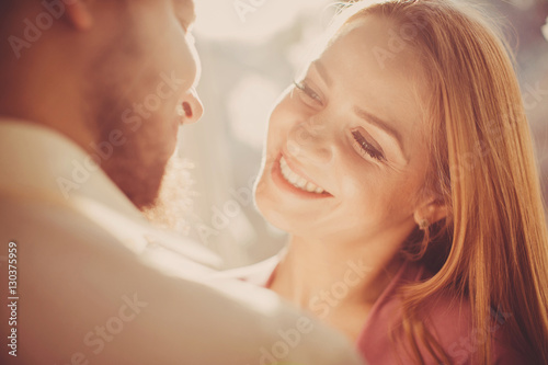 Fotografi Portrait of happy young couple looking at each other and smiling