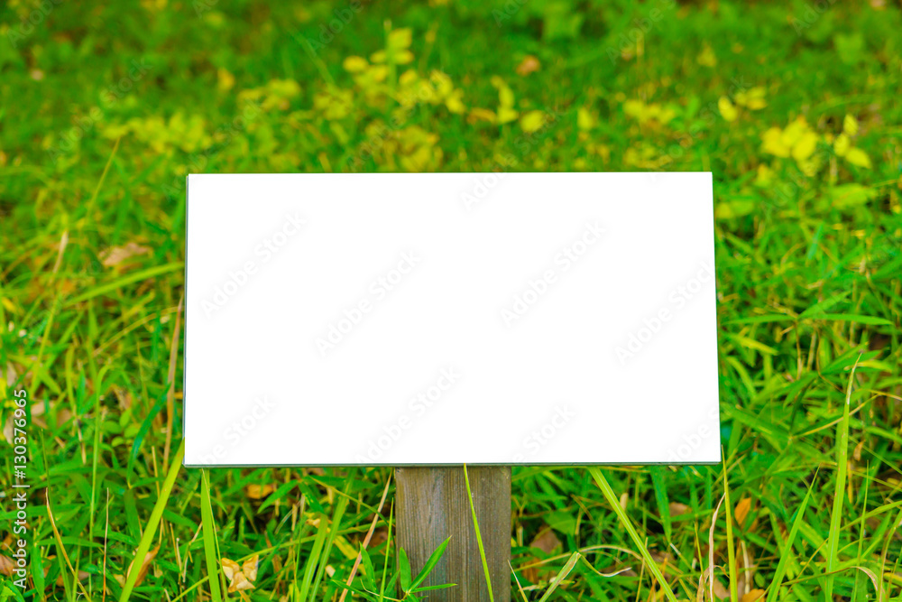 Wood sign on grass Wood sign on grass