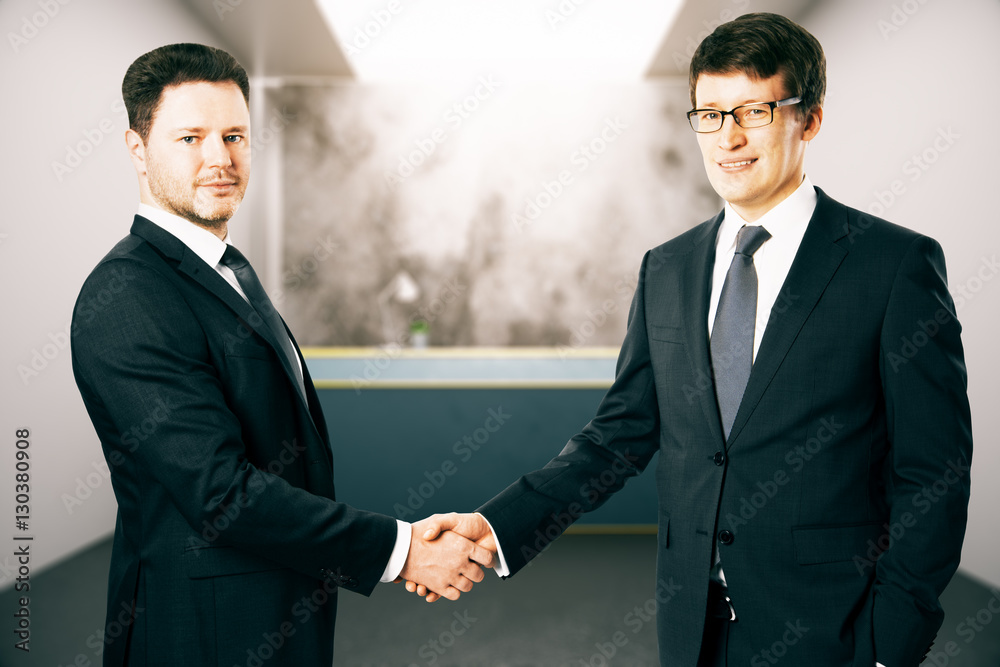 Cheerful businessman shaking hands Cheerful businessman shaking hands