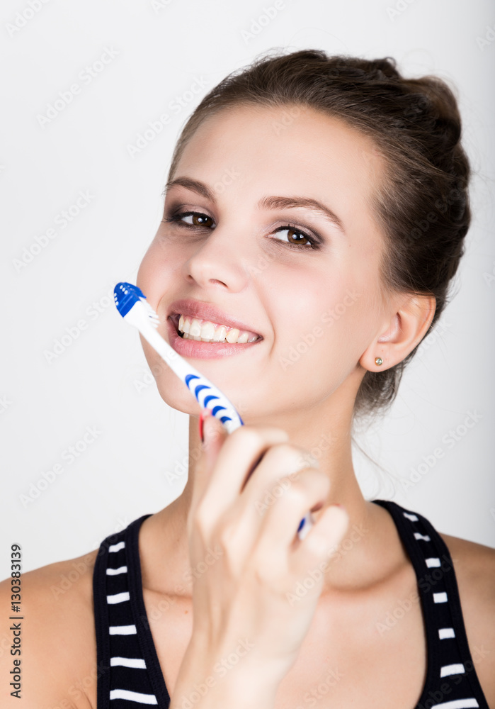 Close-up of a young woman is brushing her teeth. Dental health care concept. Close-up of a young woman is brushing her teeth. Dental health care concept.