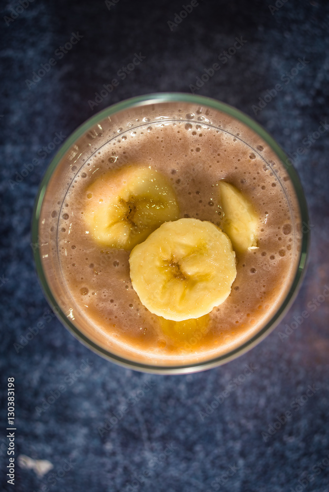Fresh banana smoothie in a glass. Top view Fresh banana smoothie in a glass. Top view