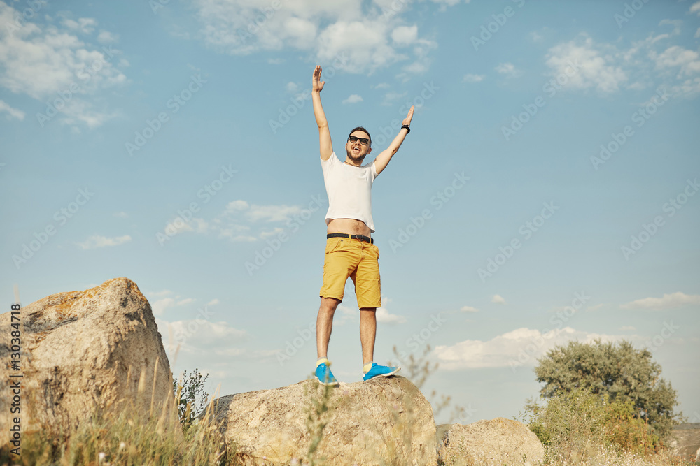Young man smiling and enjoying sunny summer day Young man smiling and enjoying sunny summer day