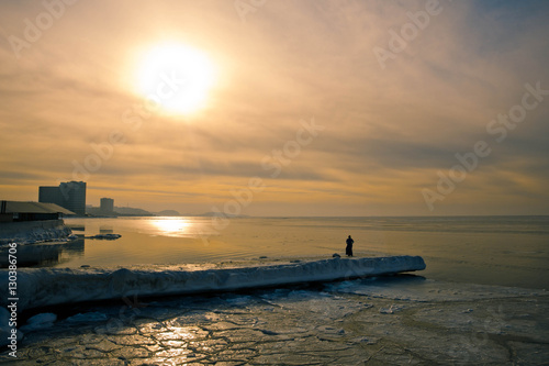 View of snow covered piers on frozen Blue sky photo