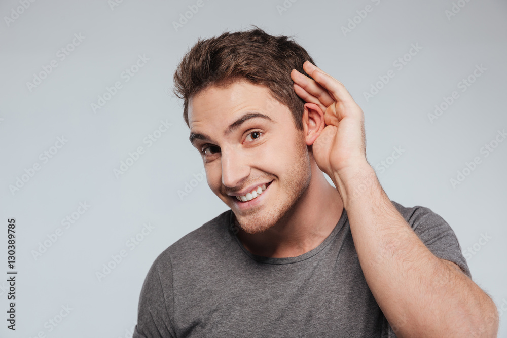 Portrait of young casual man which overhears conversation Portrait of young casual man which overhears conversation