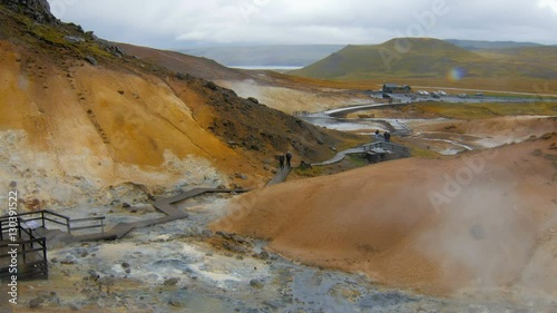 tourists are strolling in Seltun, Krysuvik in Iceland in cloudy wet weather,drop of rain in a camera photo