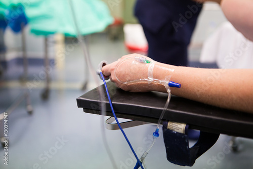 Close up of an IV drip on a female patient in an operating theatre