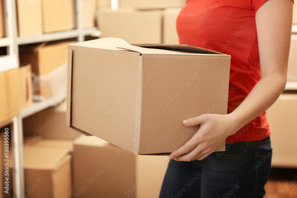 Woman holding box at warehouse Woman holding box at warehouse