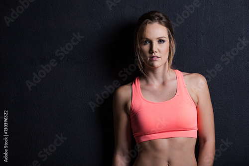 Beautiful female fitness model holding a towel/weights © Dewald