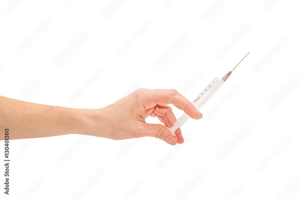Female hand holding syringe. Isolated on white. Female hand holding syringe. Isolated on white.