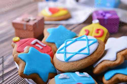 Plate with tasty glazed cookies for Hanukkah, closeup