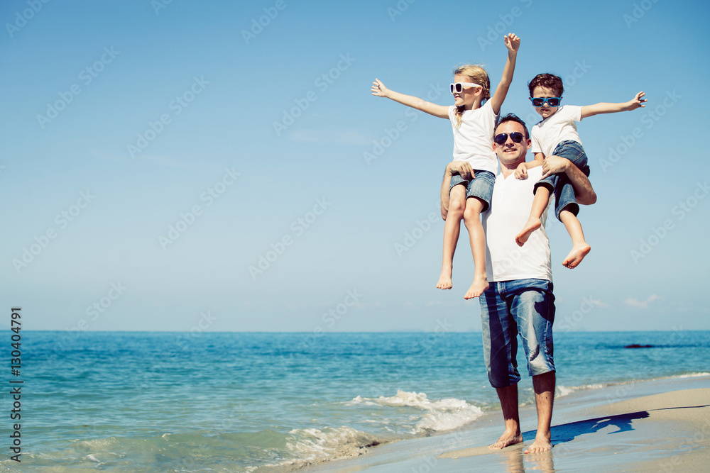 Father and children playing on the beach at the day time. Father and children playing on the beach at the day time.