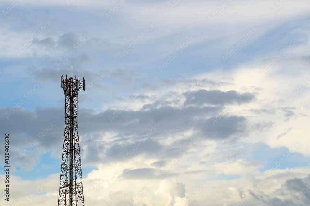 Telecommunication post against cloud and sky background.