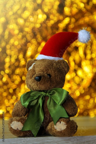 Teddy bear Christmas on golden bogeh background. photo