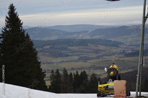 Schneekanone auf Piste mit Blick in Tal photo