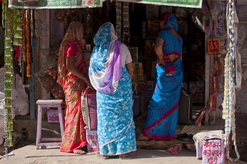 Indian women shopping, street scene Tambaku Bazar in Jodhpur Old Town, Rajasthan, Northern India photo