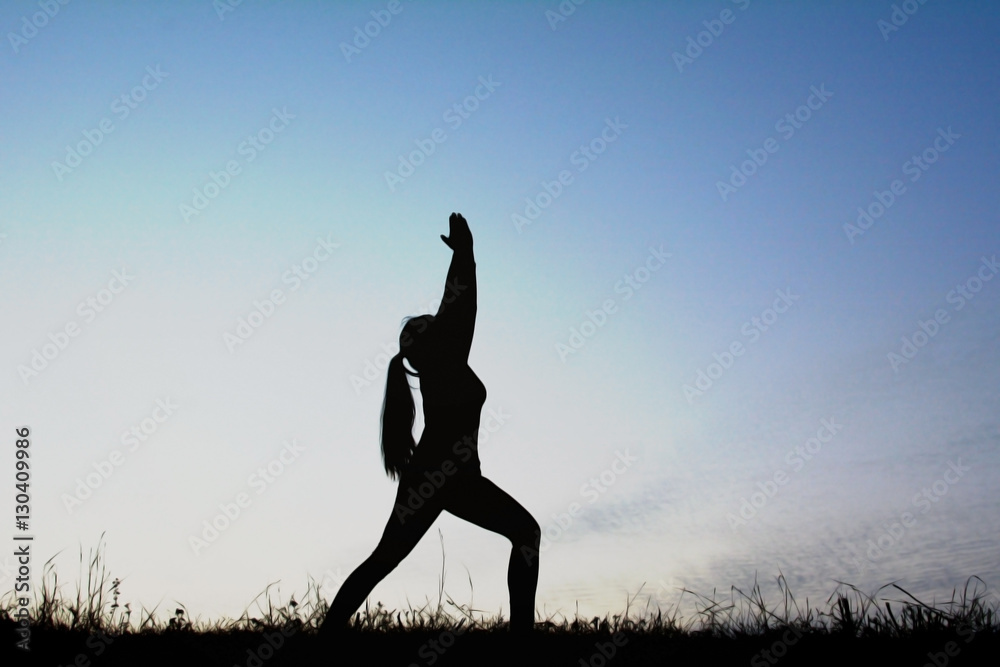 Silhouette women yoga in nature at the sky sunset, color of vintage tone