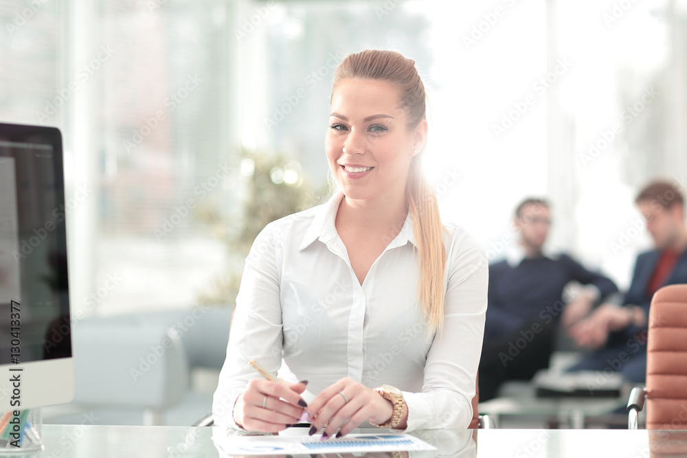 Successful business woman with her staff in background at office Successful business woman with her staff in background at office
