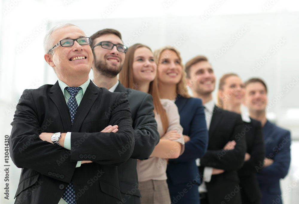 Close-up of employees of a business team standing with crossed a Close-up of employees of a business team standing with crossed a