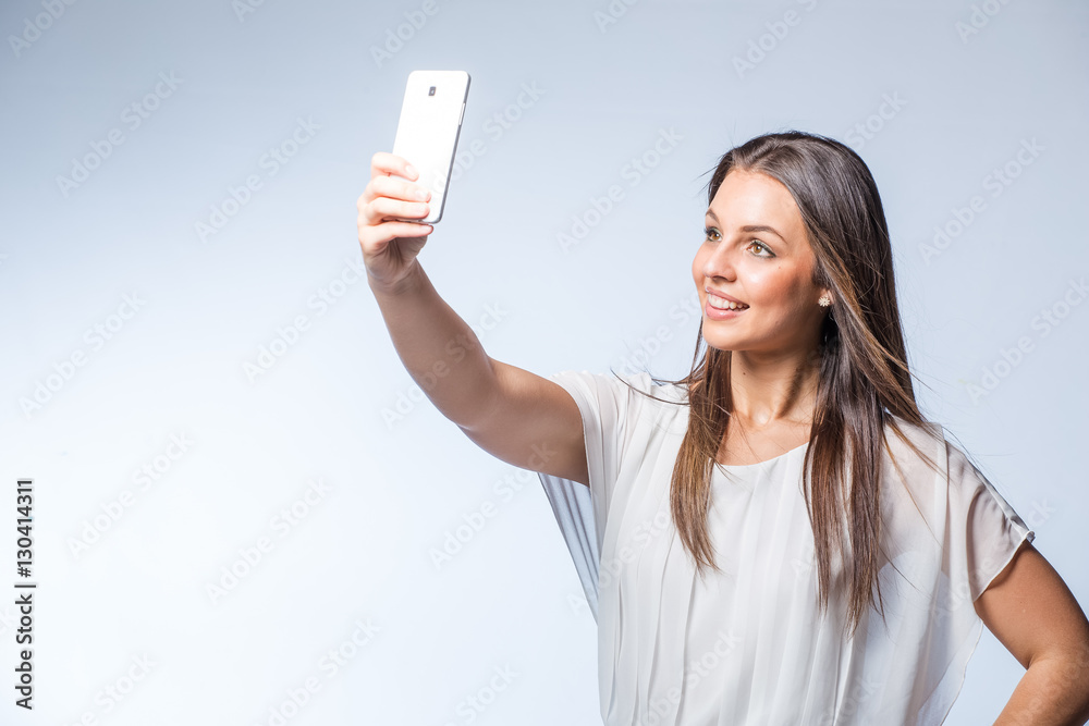 Pretty brunette business woman working on her smart phone planning business meetings or taking selfies. Pretty brunette business woman working on her smart phone planning business meetings or taking selfies.