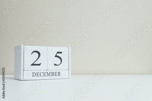 Closeup white wooden calendar with black 25 november word on blu
