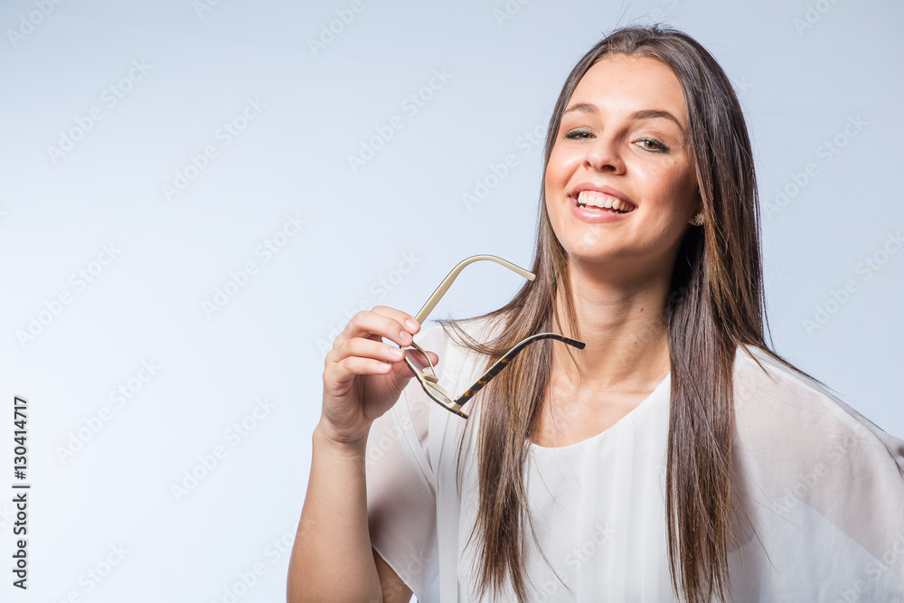 Pretty Brunette business woman with glasses on a plain background Pretty Brunette business woman with glasses on a plain background