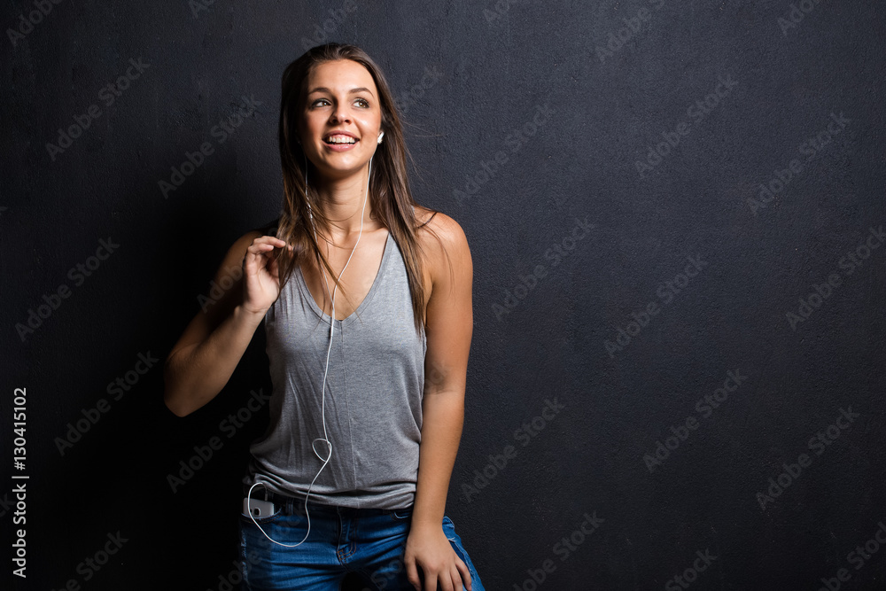 Pretty Brunette model using a smart phone to listen to music or take a selfie to load onto social meida Pretty Brunette model using a smart phone to listen to music or take a selfie to load onto social meida
