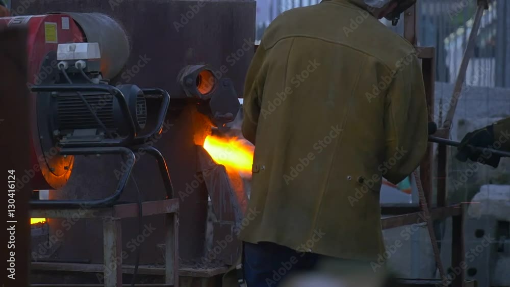 Worker is Helmet Leans Down Over Furnace Craftsmen From All Over the World Are Demonstrating Their Skills Festival of High Temperatures in Wroclaw Worker is Helmet Leans Down Over Furnace Craftsmen From All Over the World Are Demonstrating Their Skills Festival of High Temperatures in Wroclaw