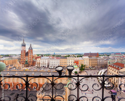 Church of St. Mary in the main Market Square on the background of dramatic sky. Basilica Mariacka. Krakow. Poland. photo