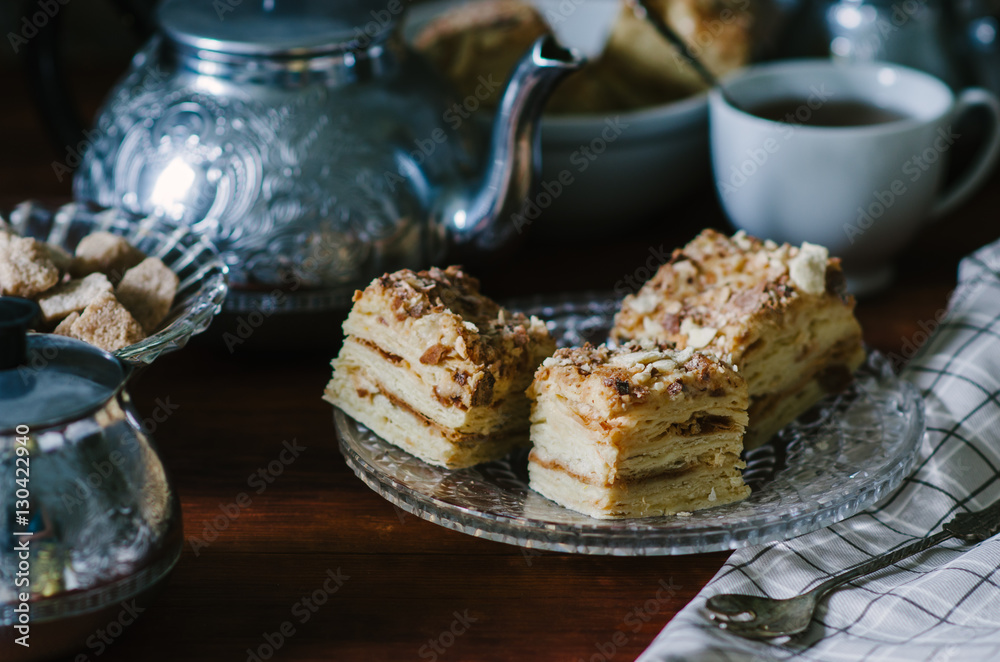 Traditional Russian homemade cake Napoleon, puff pastry custard cream pie on wooden table, rustic style