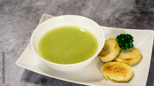 broccoli soup puree with croutons on a stone background. selective focus