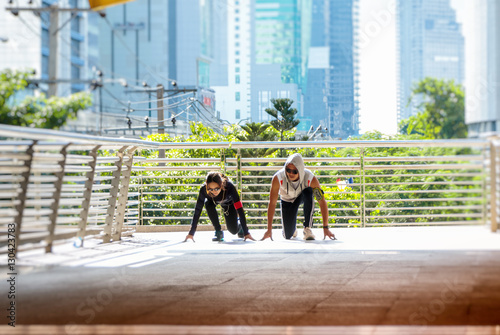 Happy sport couple start jogging together in city environment photo
