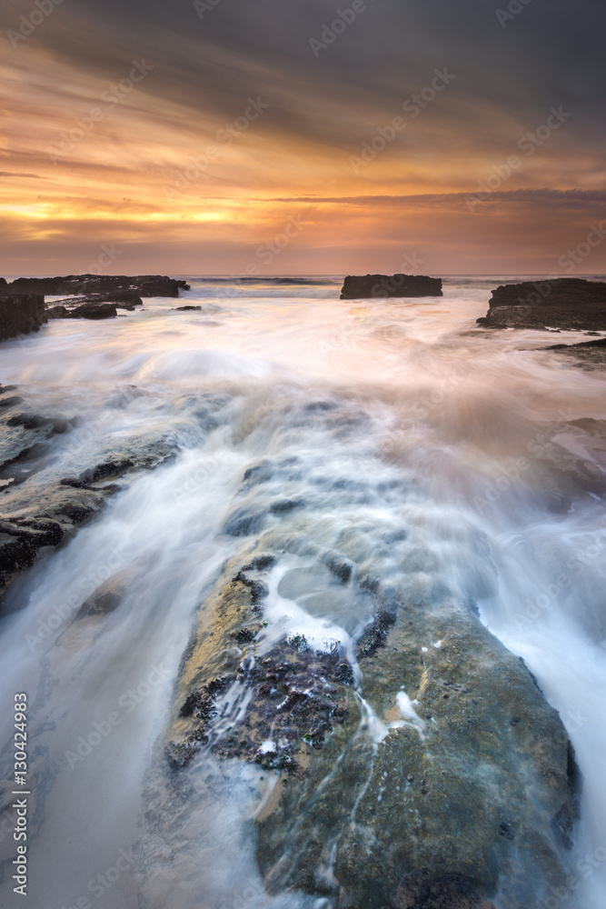 Sunset with high tide on isolated beach