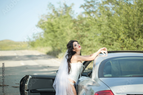 beautiful girl in the corset next to the car © vdeineka
