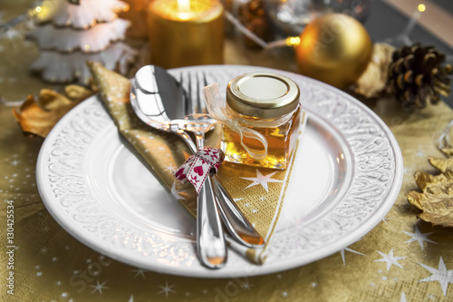 Christmas table set with honey jar gift for guests