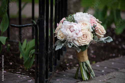 Wedding bouquet for the bride and bridal party with peonies, roses, pink, peach and white